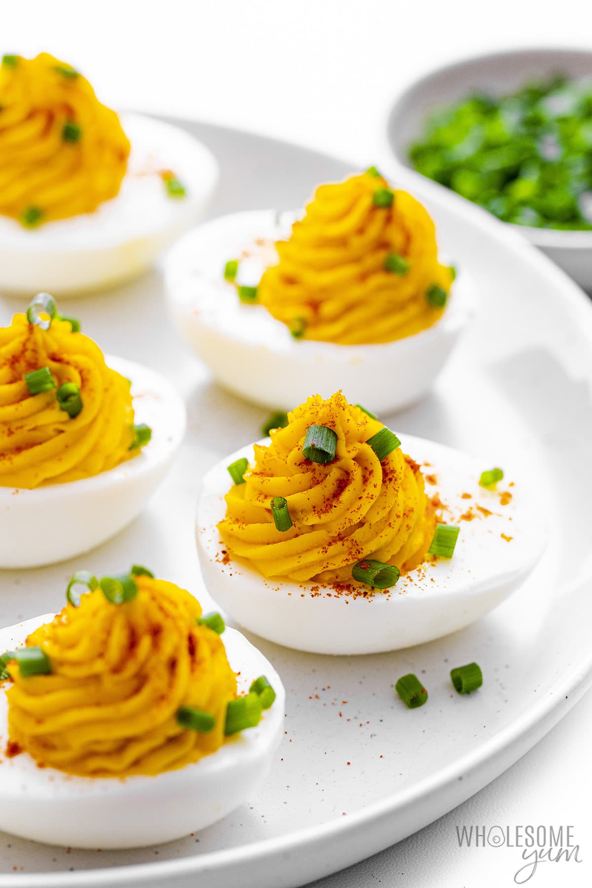 Perfect deviled eggs on a plate.