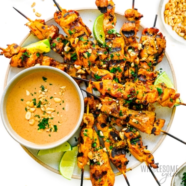 Chicken satay on a plate.
