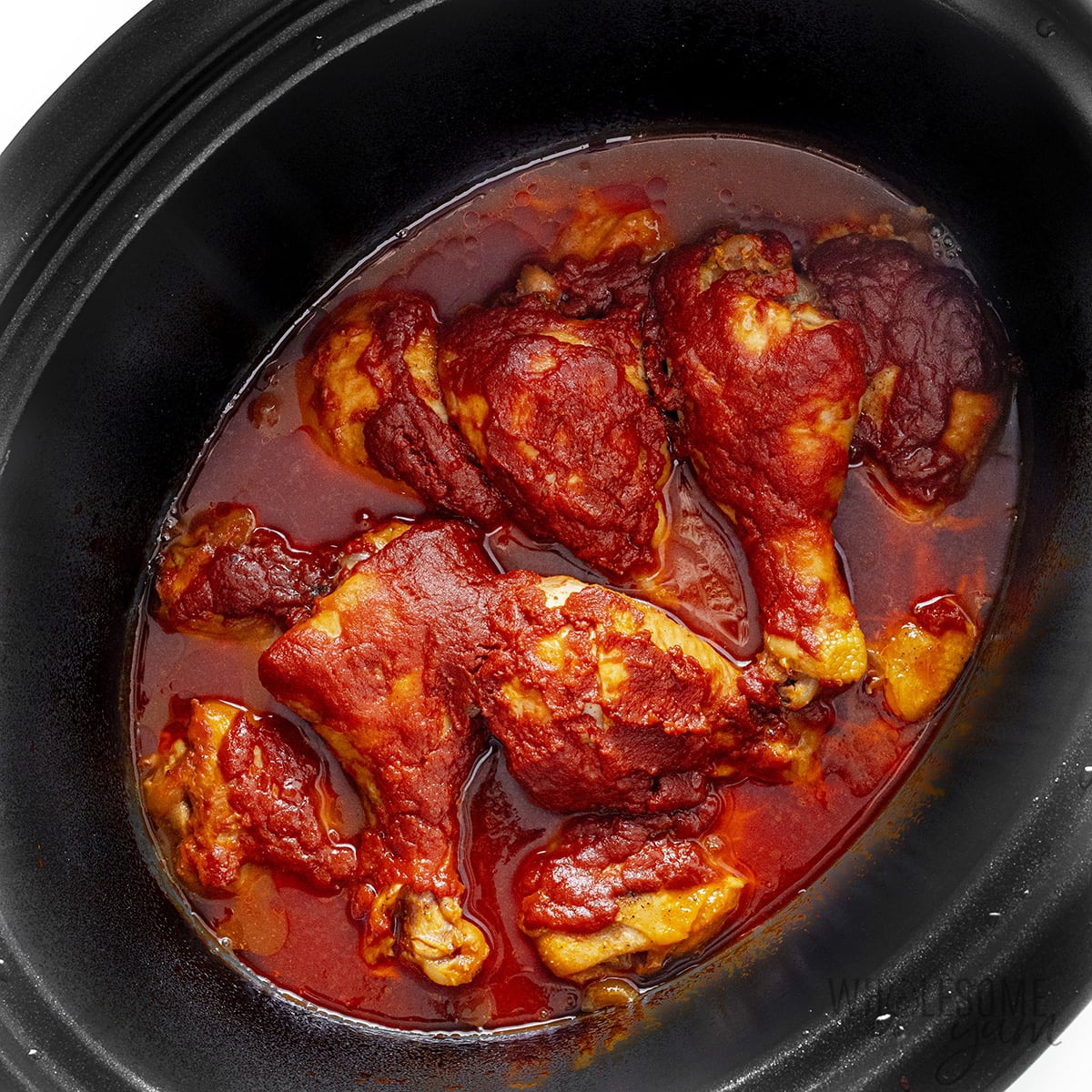 Cooked chicken legs in the Crock Pot.