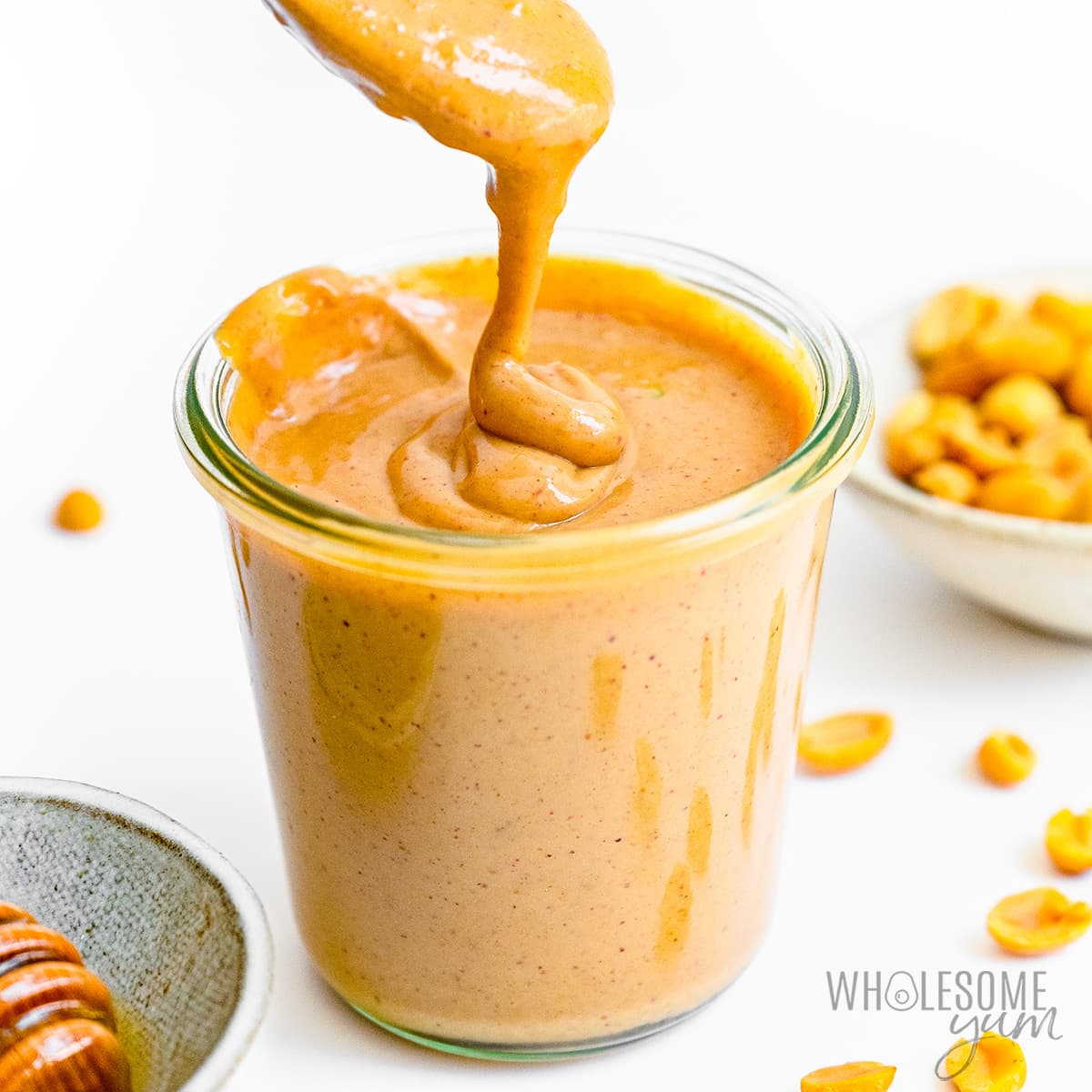 Peanut sauce recipe drizzled from spoon.