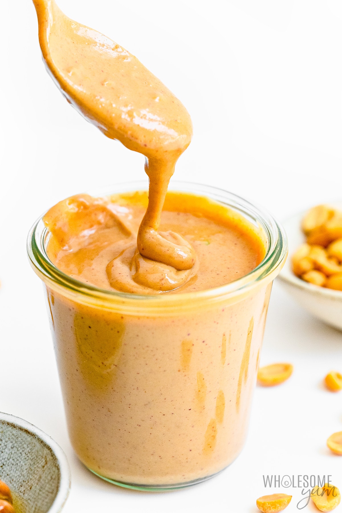 Satay sauce in a jar with spoon.