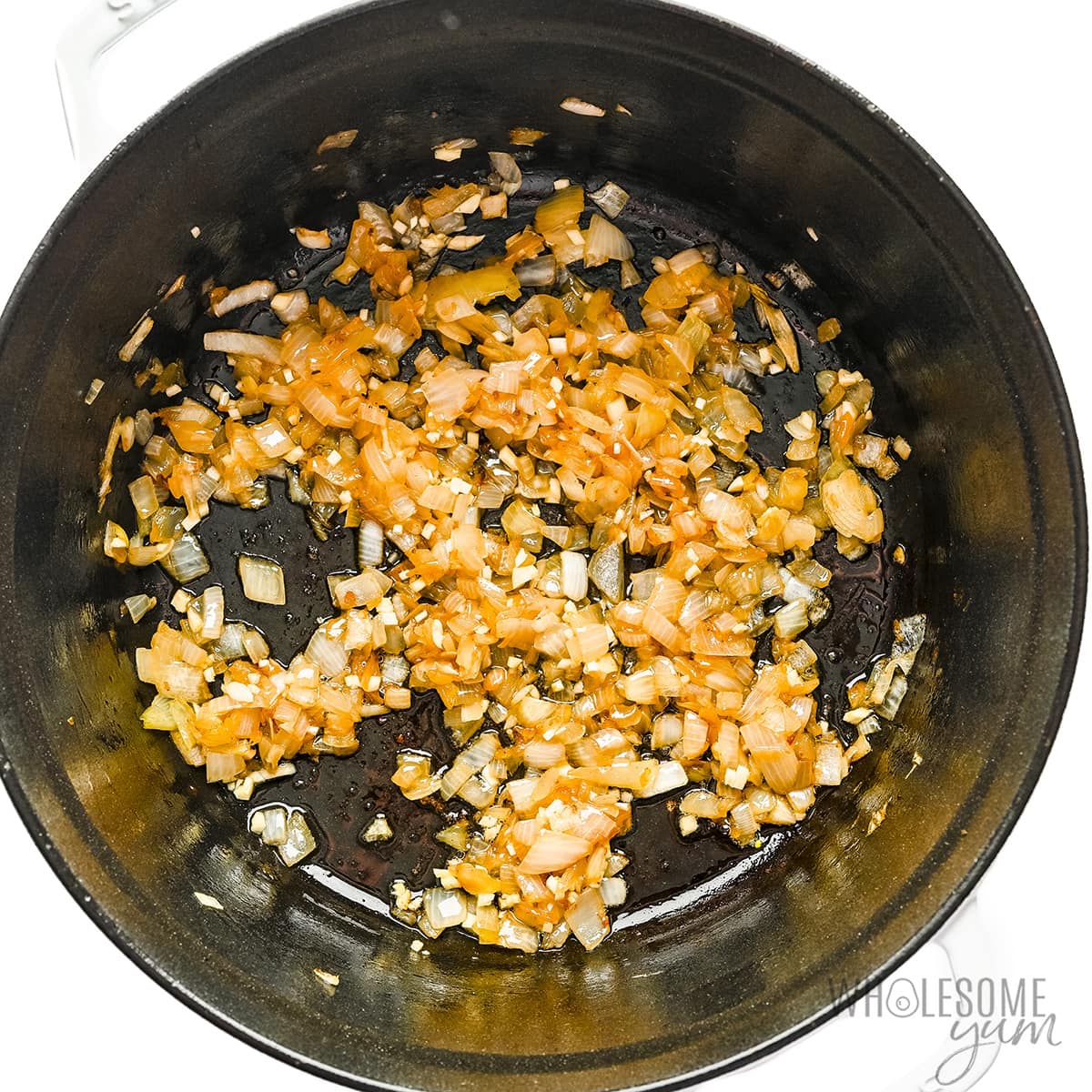 Garlic and onion sauteed in a skillet.