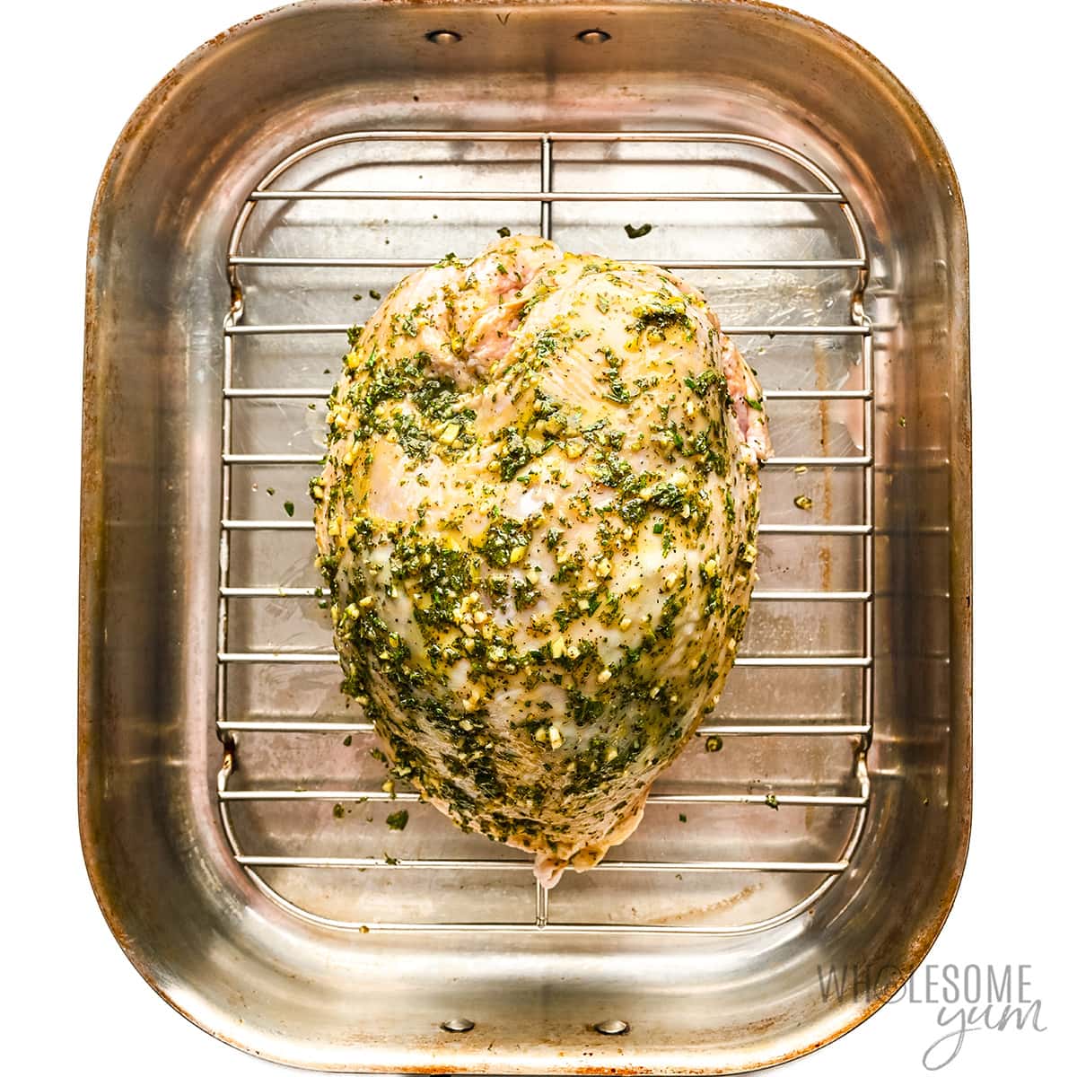 Place seasoned turkey breast in roasting pan.