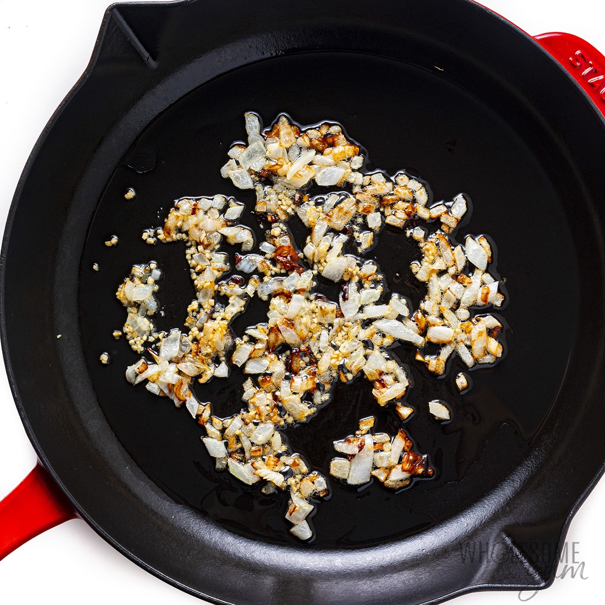 Sauteed garlic and onions in a skillet.