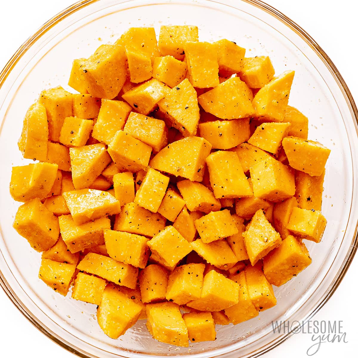 Sweet potato cubes seasoned in a bowl.