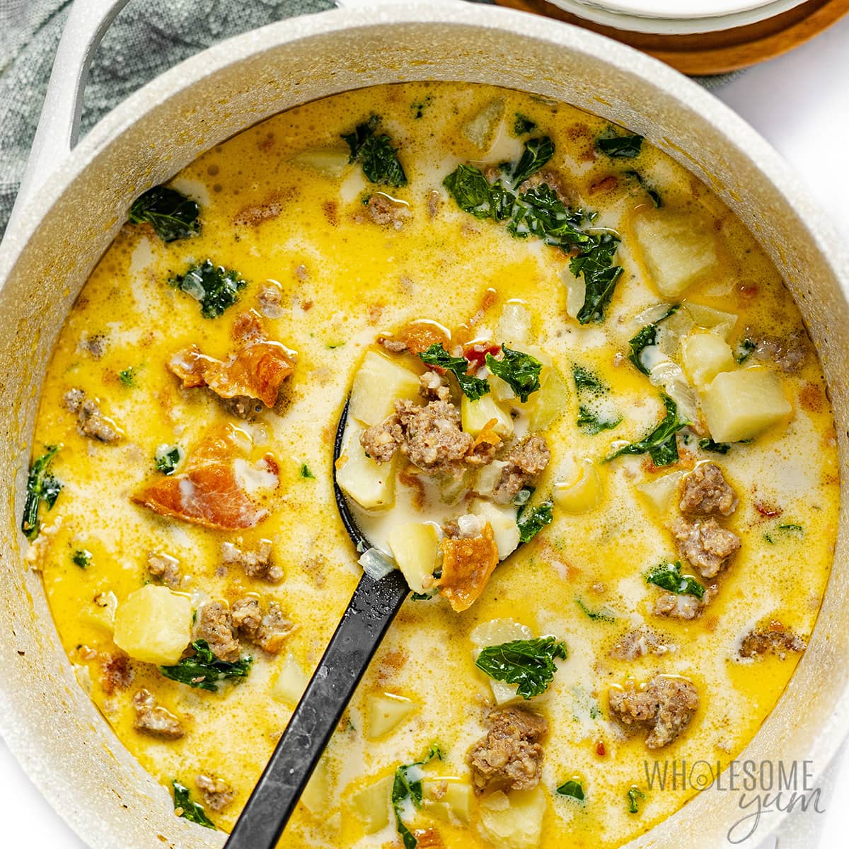 Zuppa Toscana soup in a bowl with a spoon.