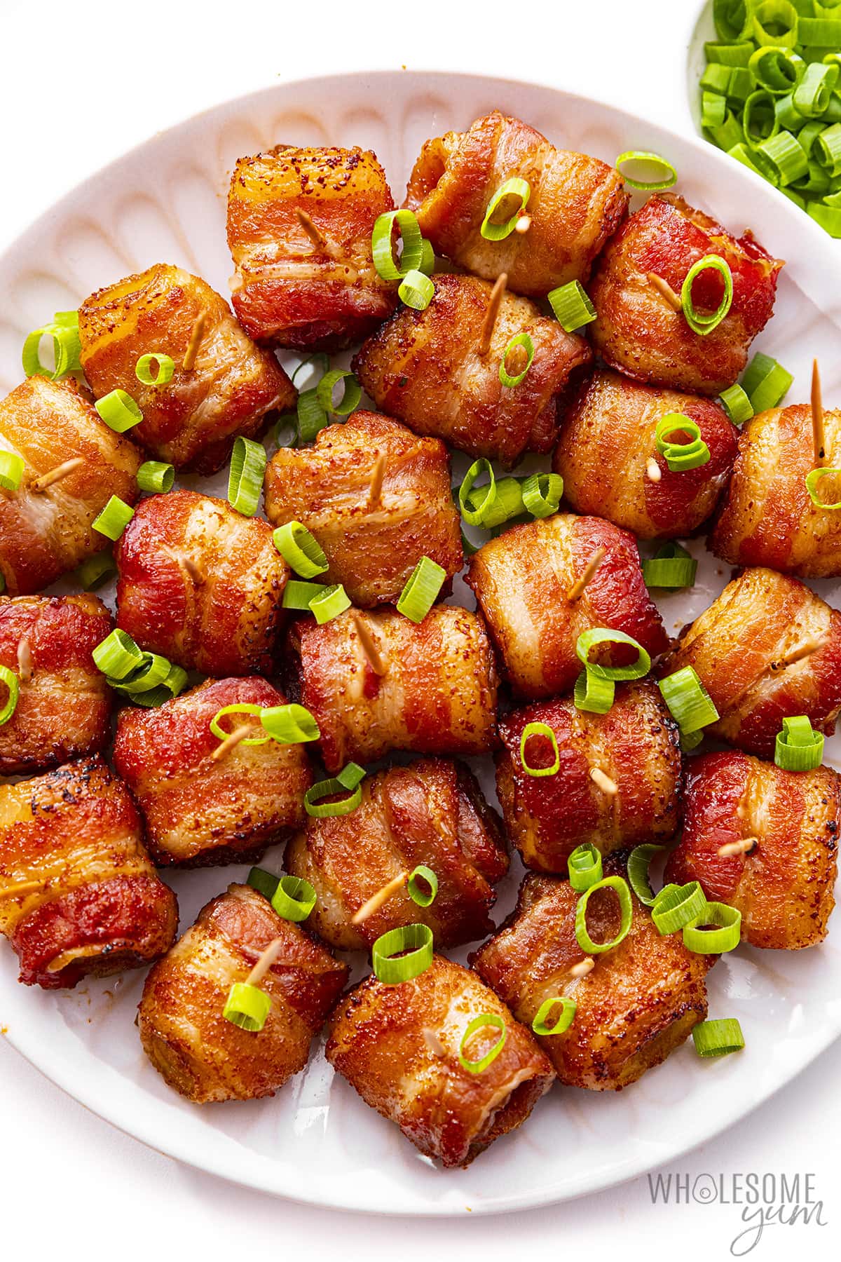 Bacon wrapped water chestnuts on a plate.