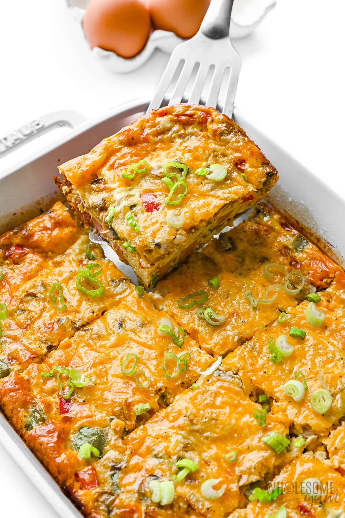 Easy breakfast casserole with slice being removed using a spatula.