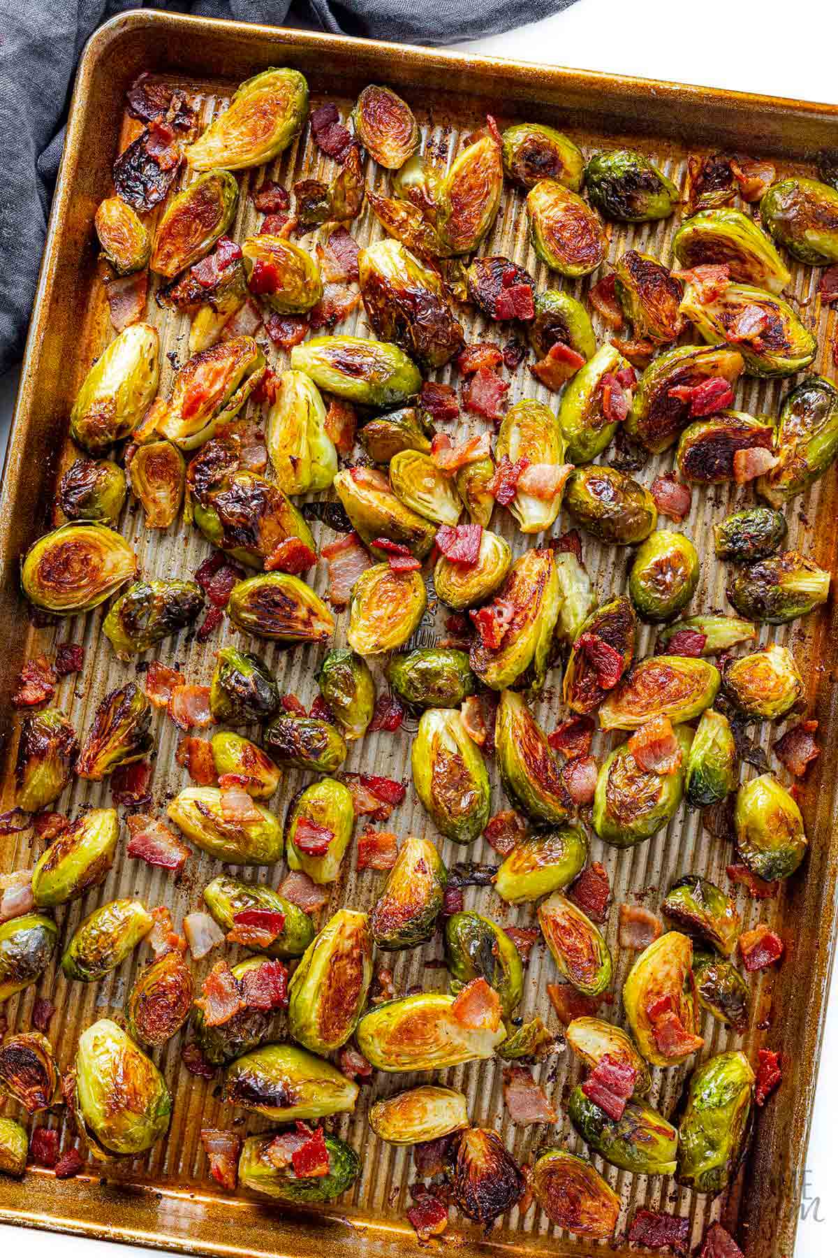 Brussels sprouts with bacon on a sheet pan.