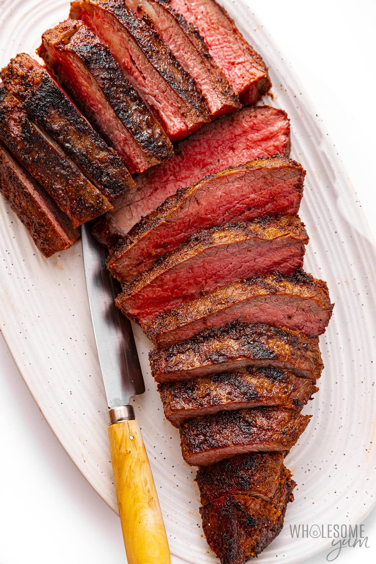 Tri-tip roast is sliced ​​thinly with a knife.