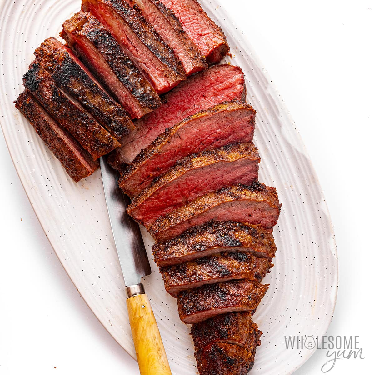 Place roasted tri-tip slices on a plate.