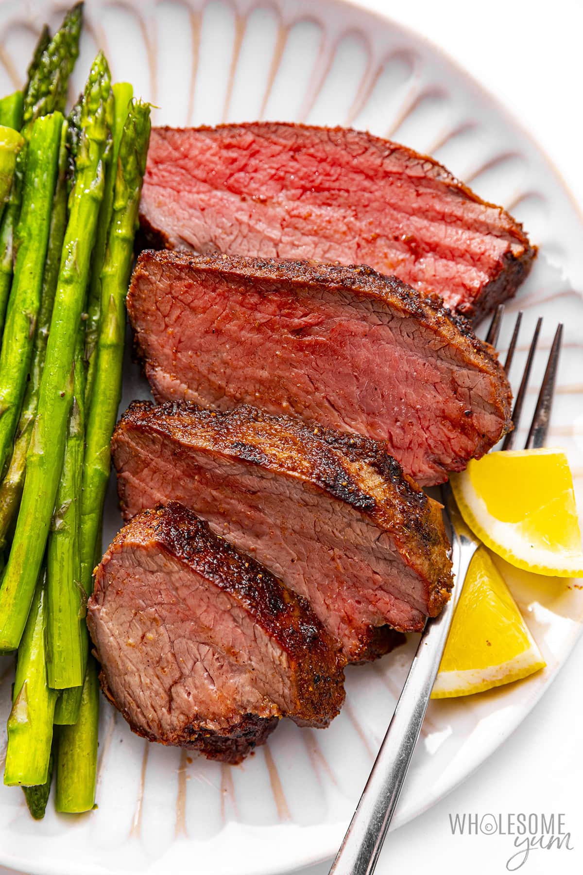 Place tri-tip slices on a plate with asparagus.