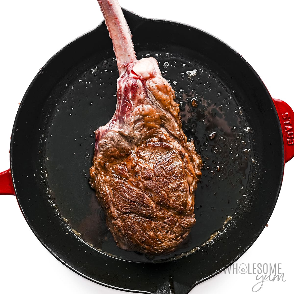 Seared steak in a cast iron skillet.