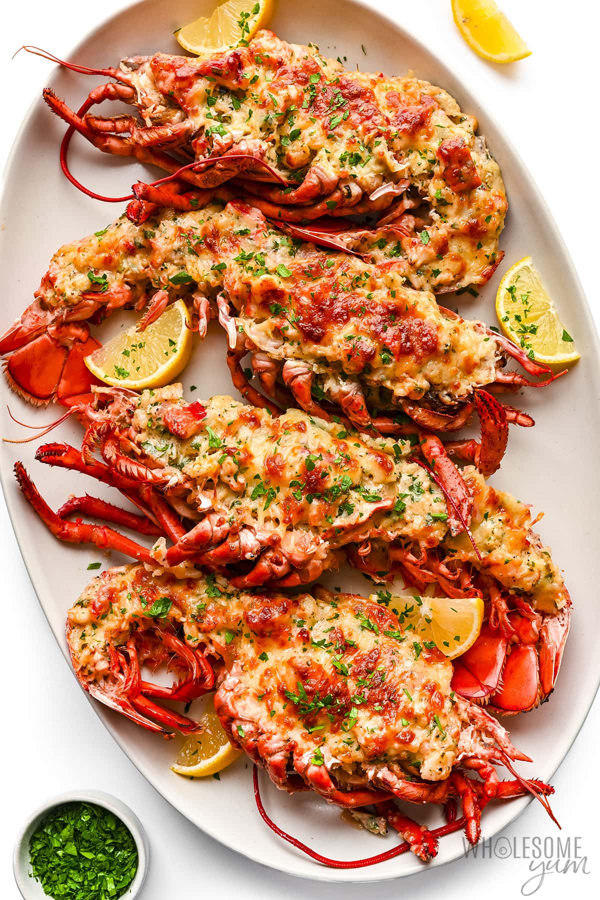 Lobster Thermidor with lemon wedges.