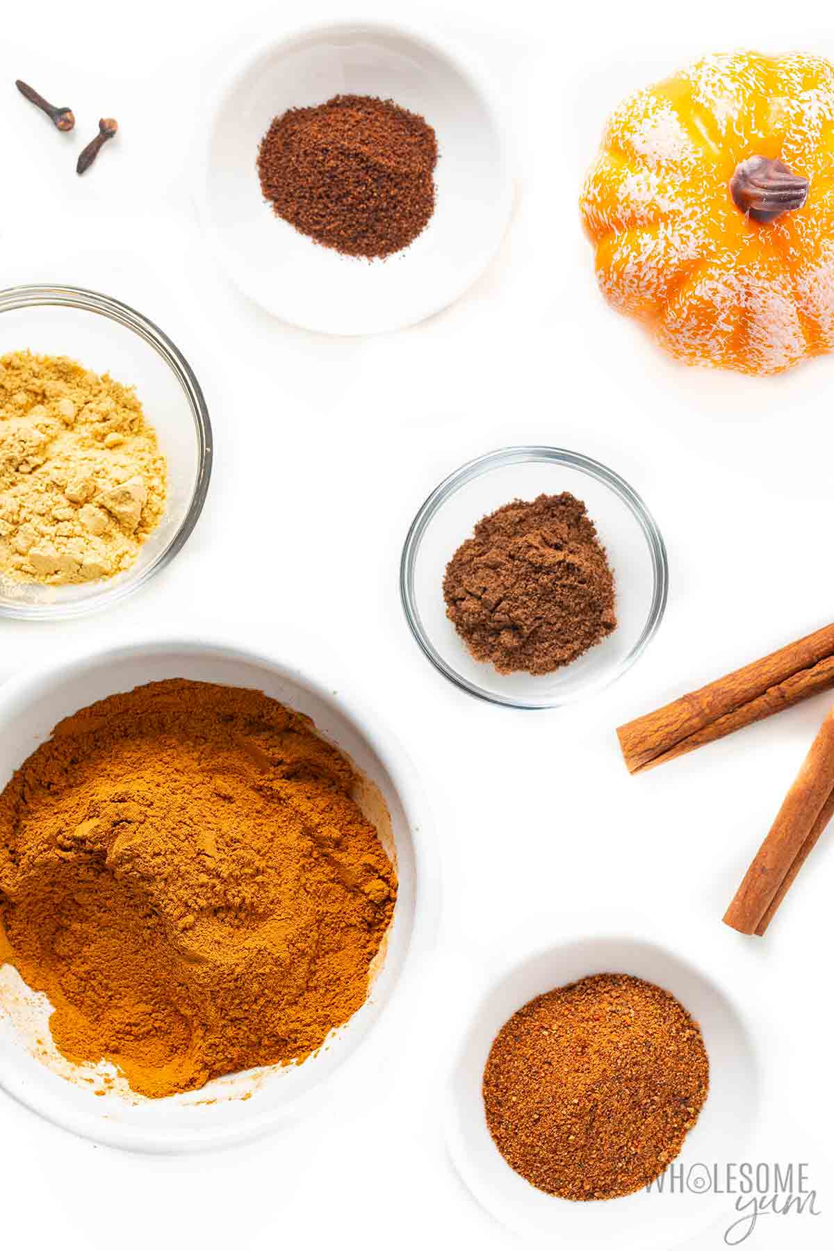 Pumpkin spice ingredients measured out in bowls.
