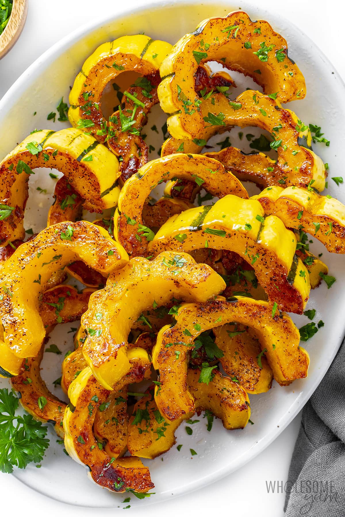 Roasted delicata squash on a plate.