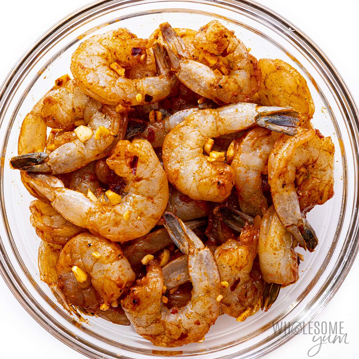 Shrimp coated with spices in a bowl.