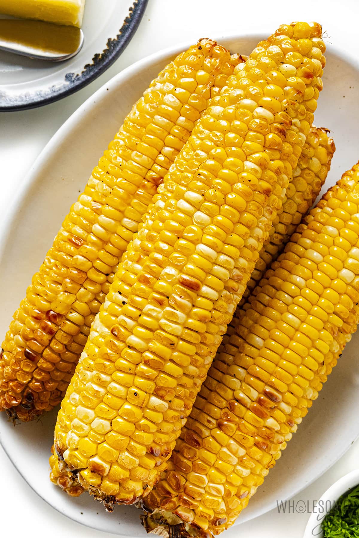 Air fryer corn on the cob on a plate.
