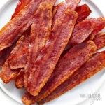 Turkey bacon in the oven on a plate.