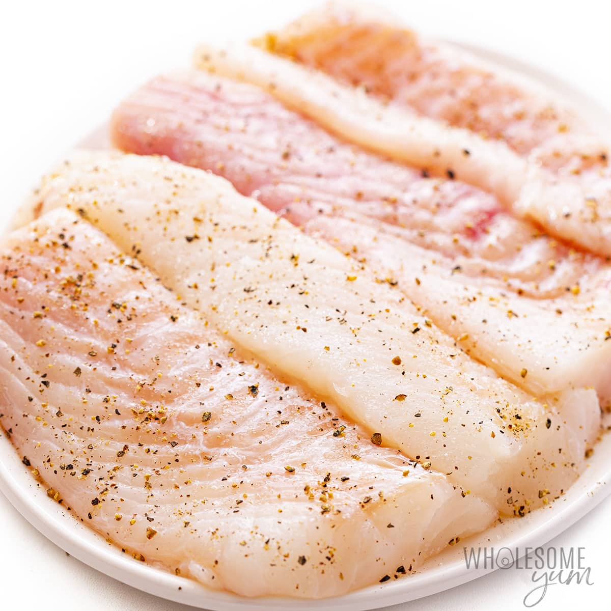 Fish seasoned with salt and pepper.