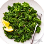 Sauteed kale on a plate with a fork.