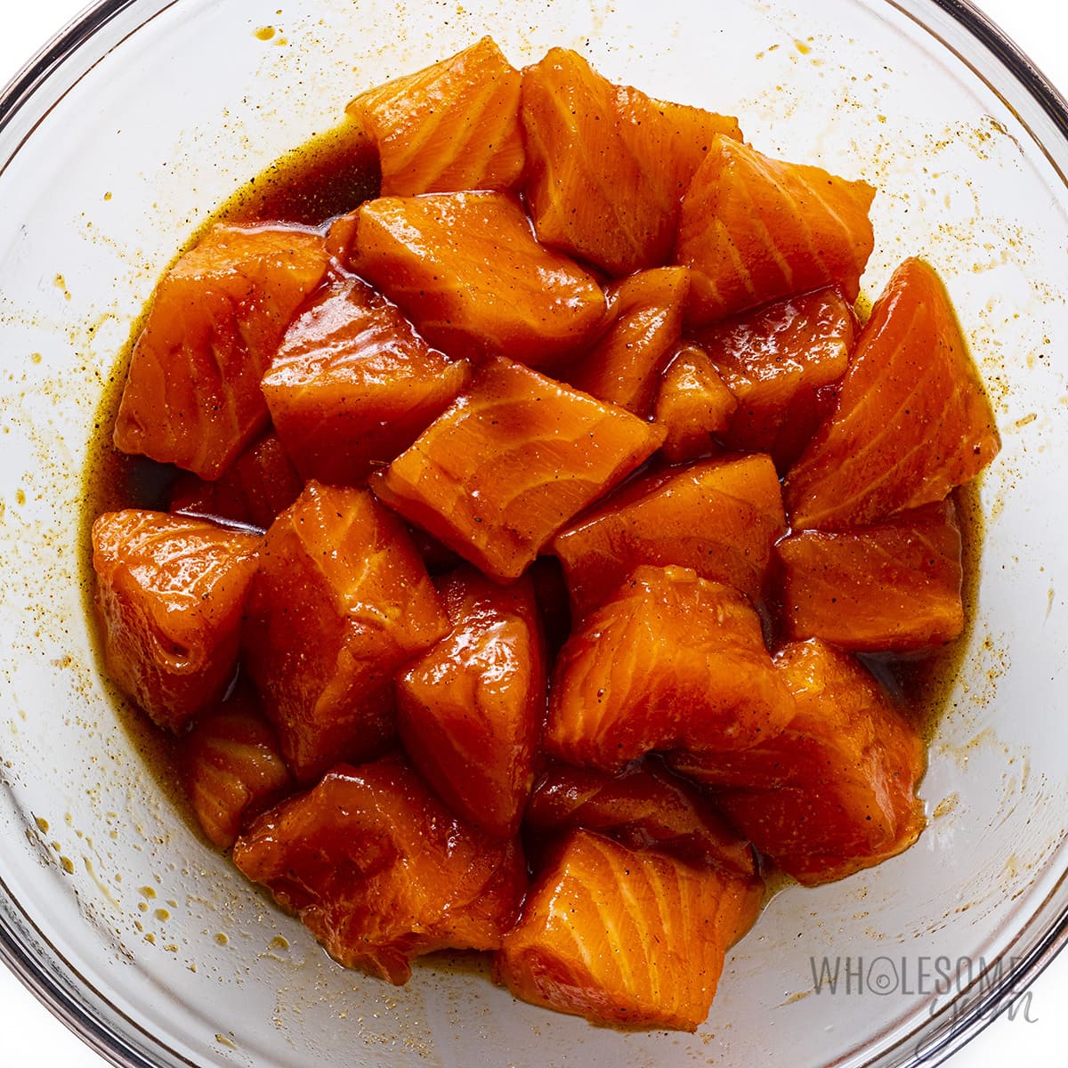Cut salmon pieces in a bowl marinating.
