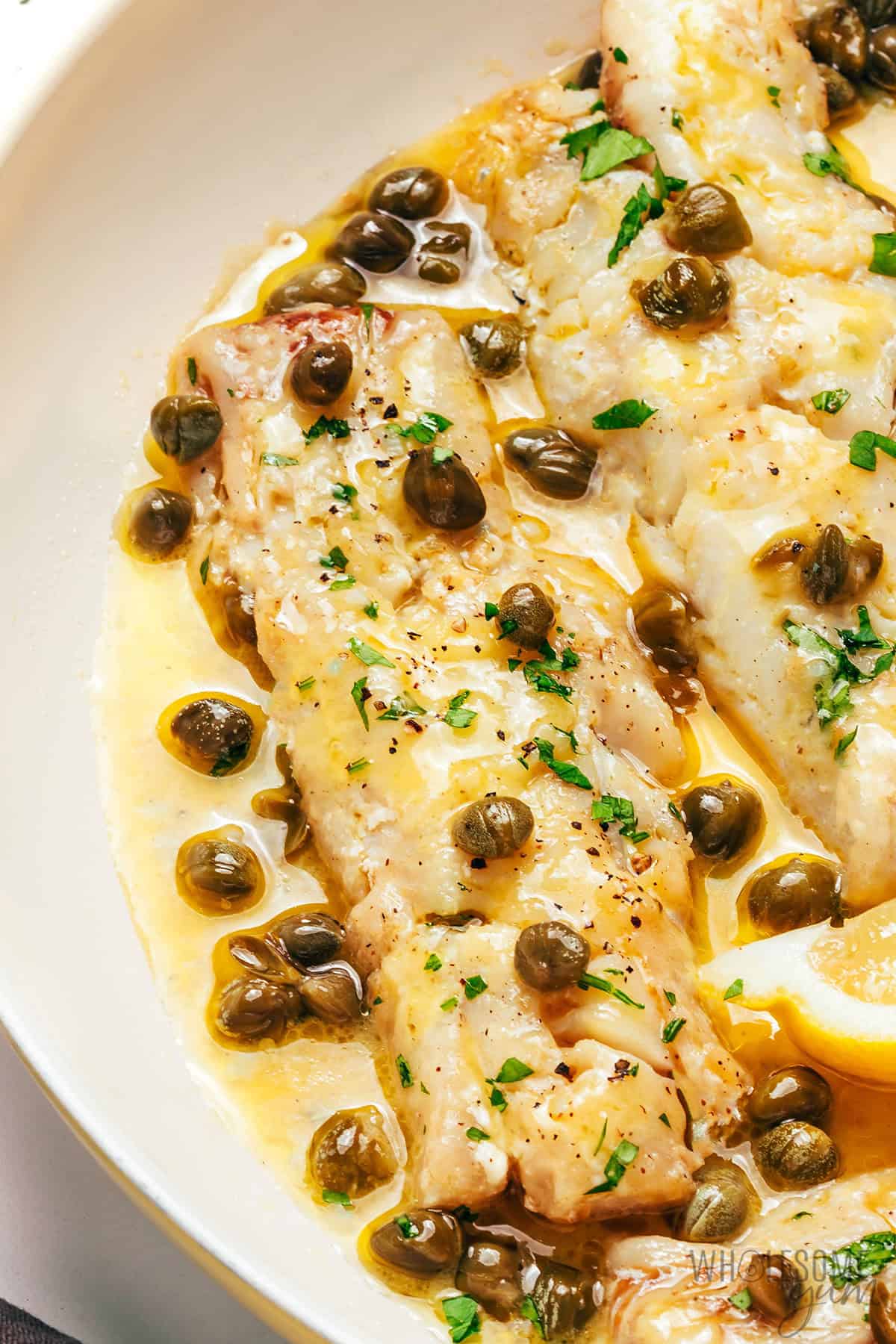 Flaky pan fried cod with lemon butter sauce and capers.