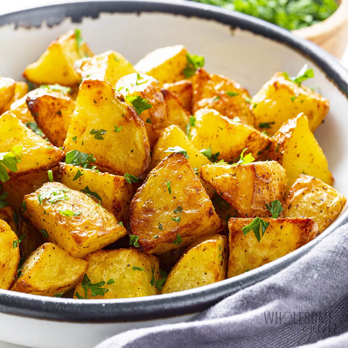 Air fryer potatoes garnished with parsley.