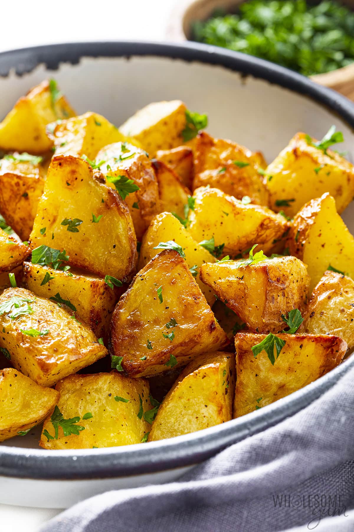 Air fryer potatoes in a serving bowl.