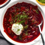 Borscht soup in a bowl with a spoon.