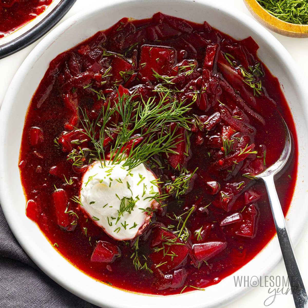 Borscht soup in a bowl with a spoon.