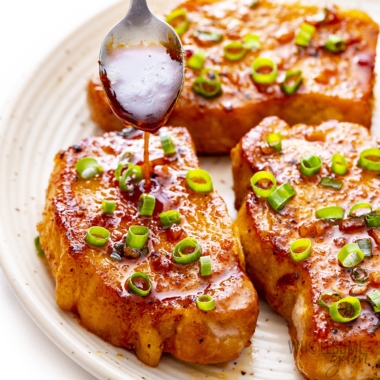 Honey garlic pork chops drizzled with sauce.
