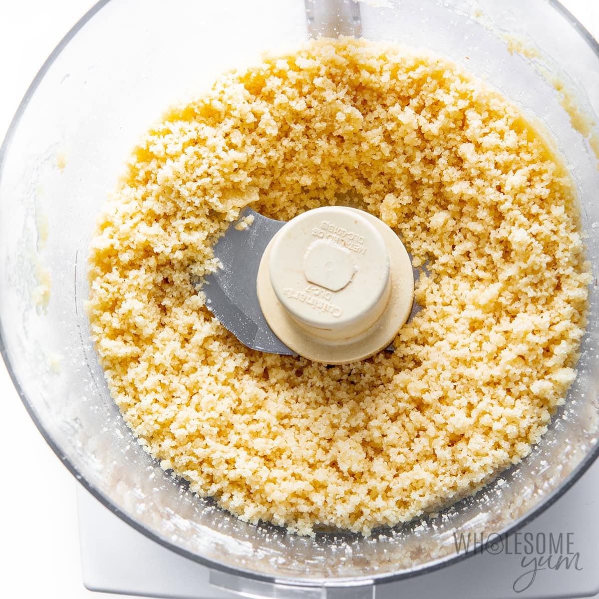 Dry ingredients mixed with melted butter in a food processor.