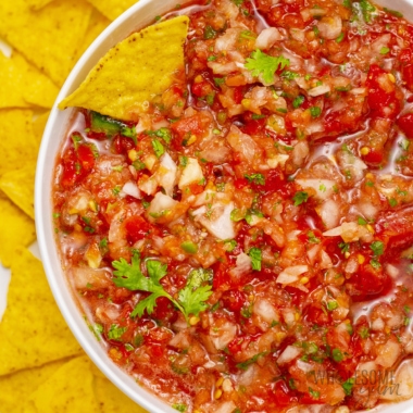 Fresh salsa recipe in a bowl with chips.