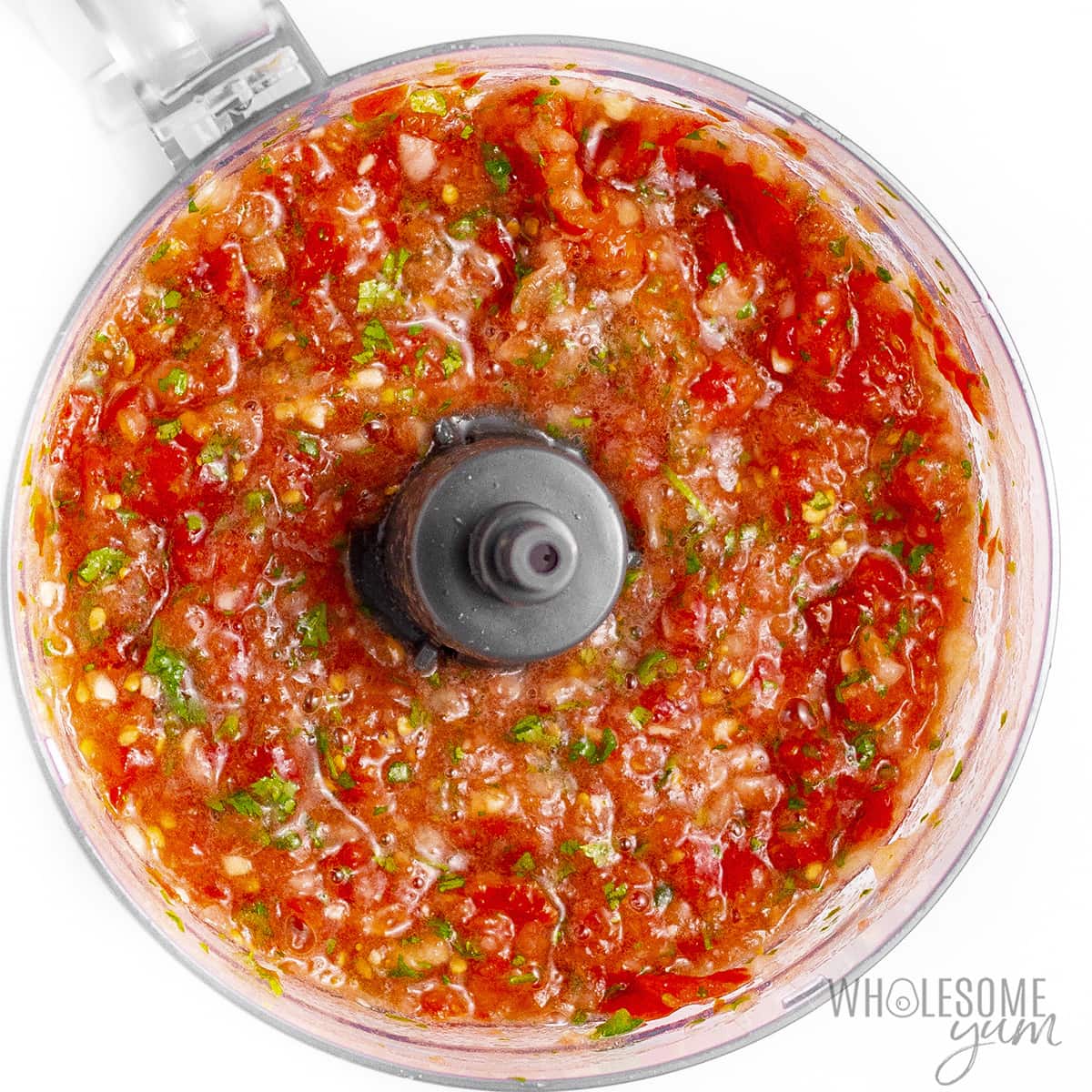 Blended fresh salsa in a food processor.