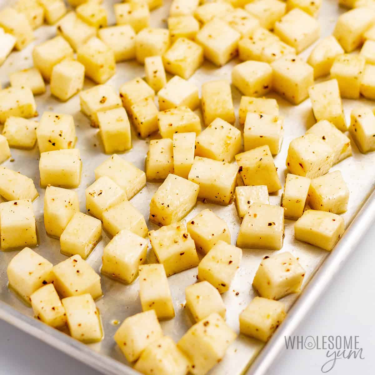Cubed rutabaga on a sheet pan.