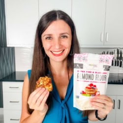 Me with a chicken fritter in one hand and bag of almond flour in the other.