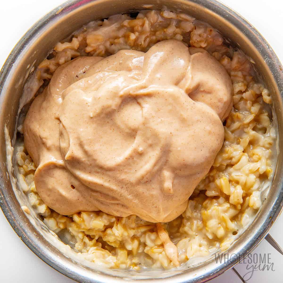 Blended banana mixture scooped over the oats.