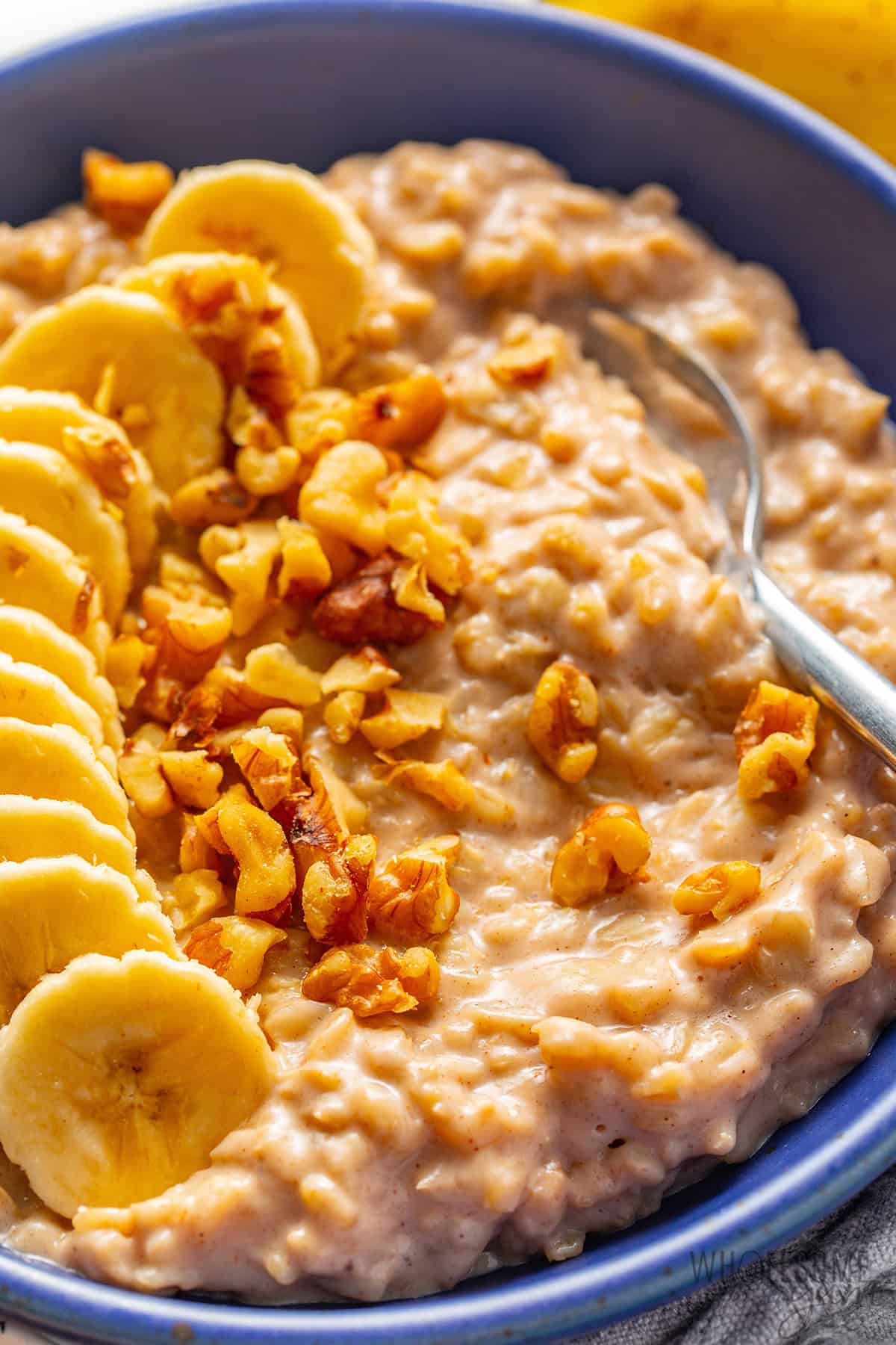 Creamy banana oatmeal with banana slices and walnuts.