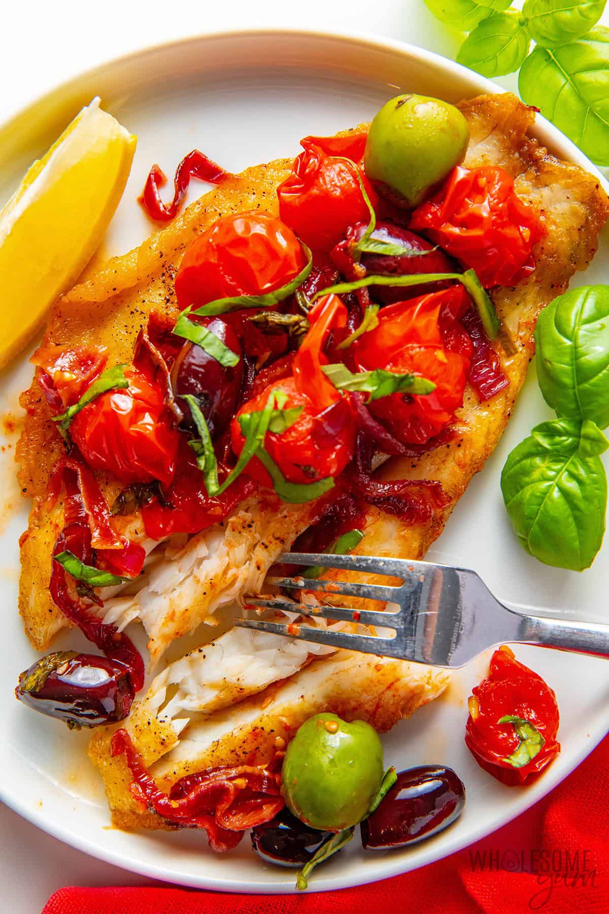Moist, flaky barramundi flaked with a fork and topped with Mediterranean toppings.