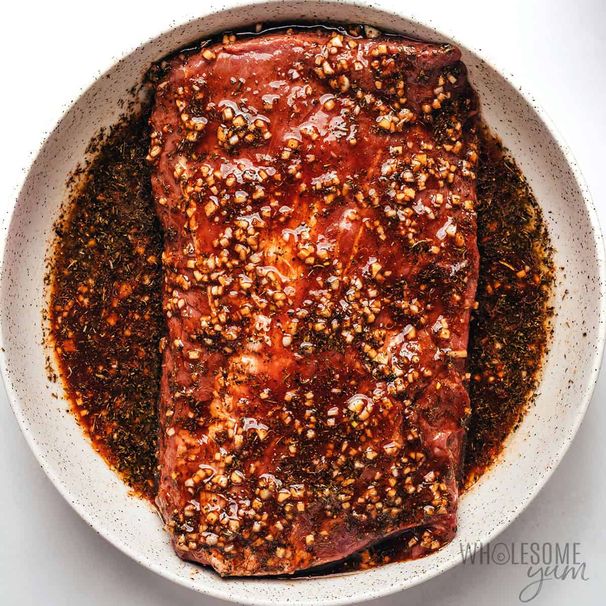 Steak marinating in the bowl.