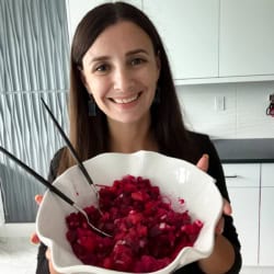 Maya holding a large serving bowl of Russian beet salad.