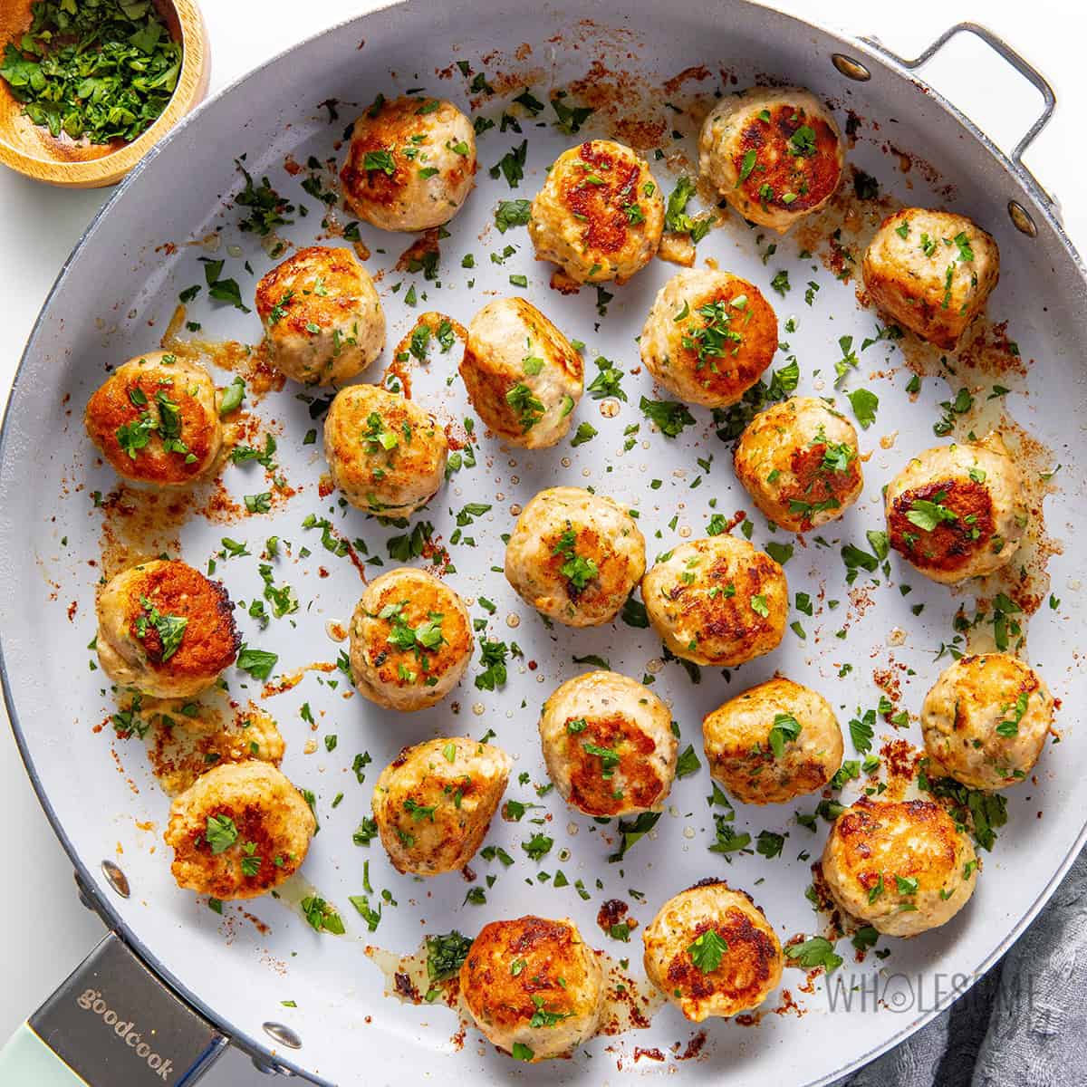 Cooked turkey meatball recipe garnished with fresh parsley.
