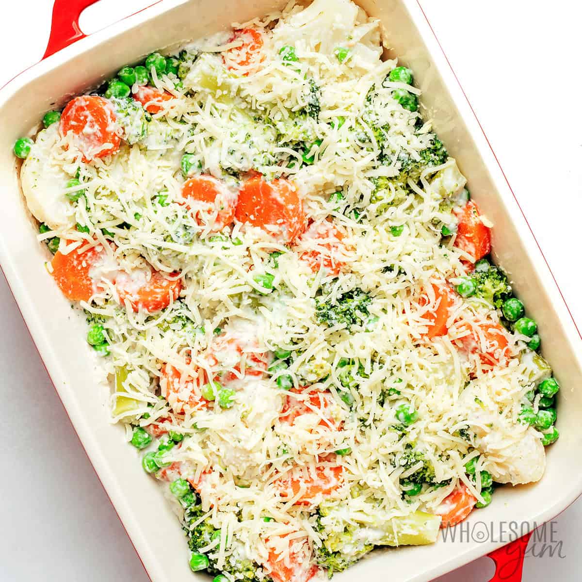 Veggies arranged in a baking dish and topped with cheese.