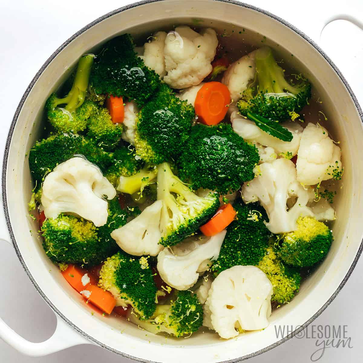Parboiling veggies in a Dutch oven until tender.