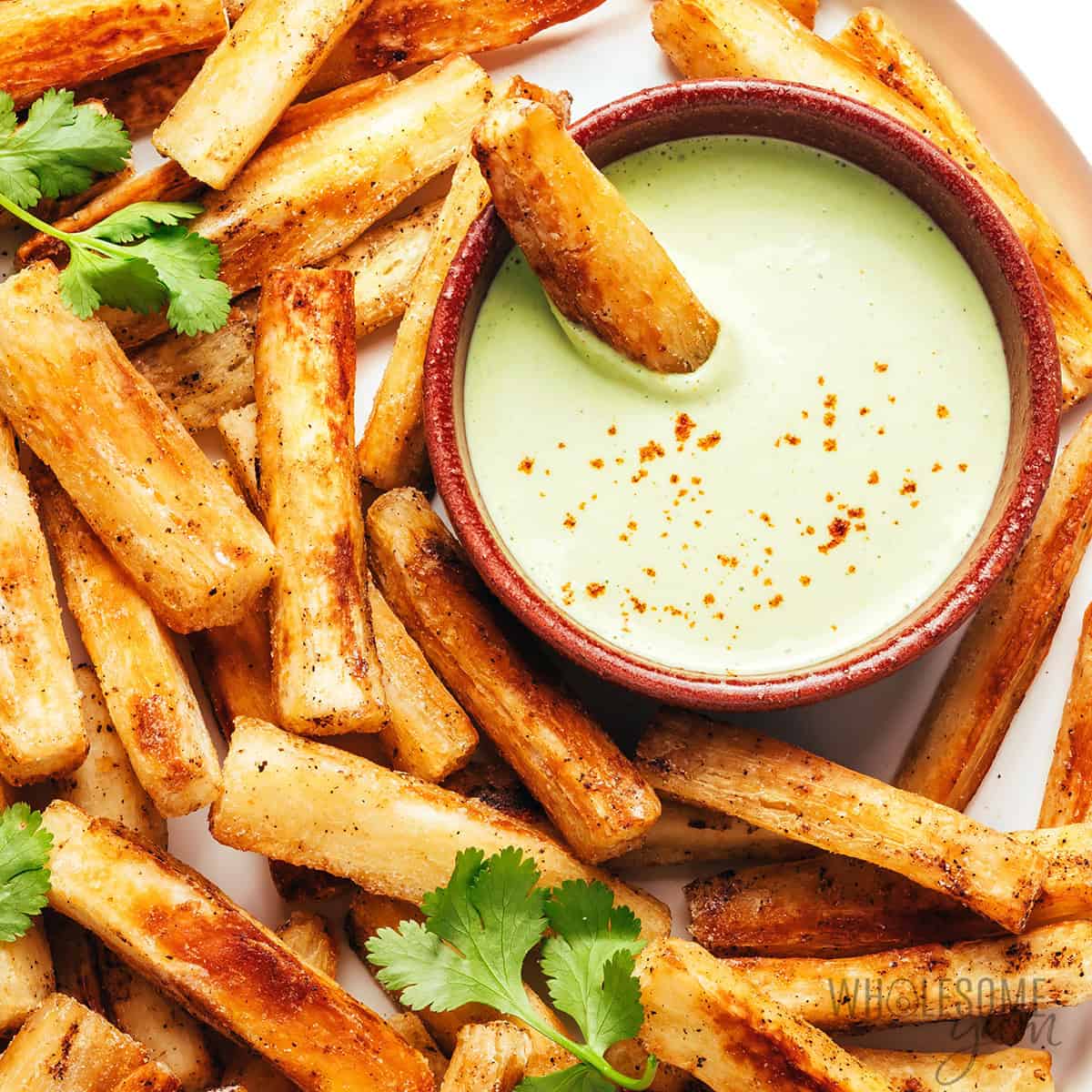 Baked yuca fries recipe with lime crema dip.