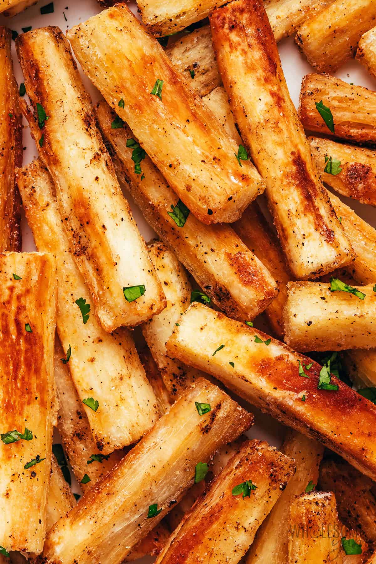 Golden, crispy cassava fries close up.