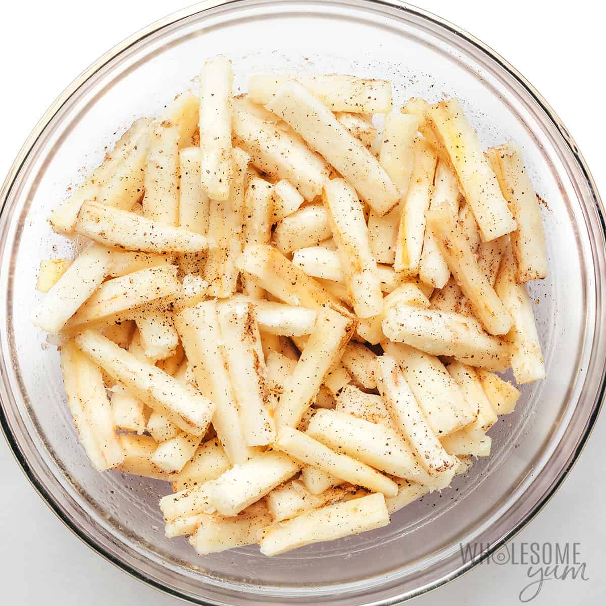 Generously seasoned fry sticks in a bowl.