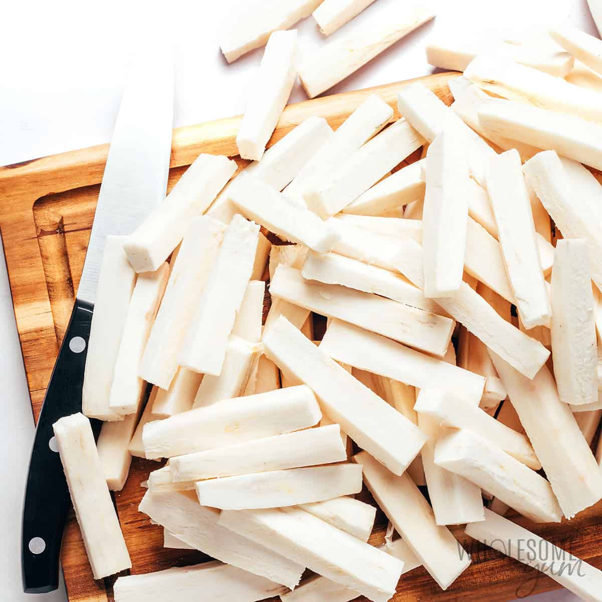 Sliced fries scattered on a cutting board.