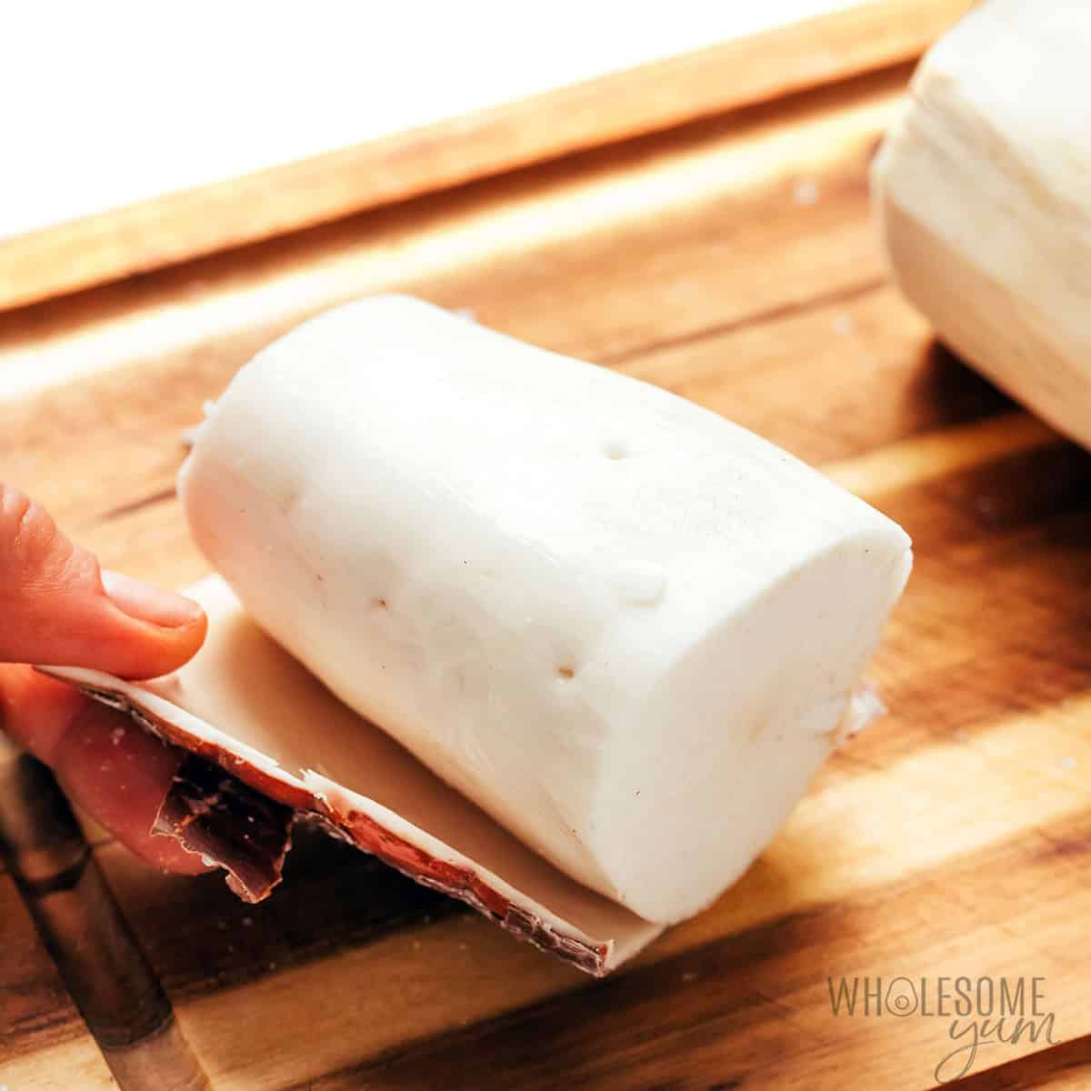 Peeling the skin off the cassava root by hand.